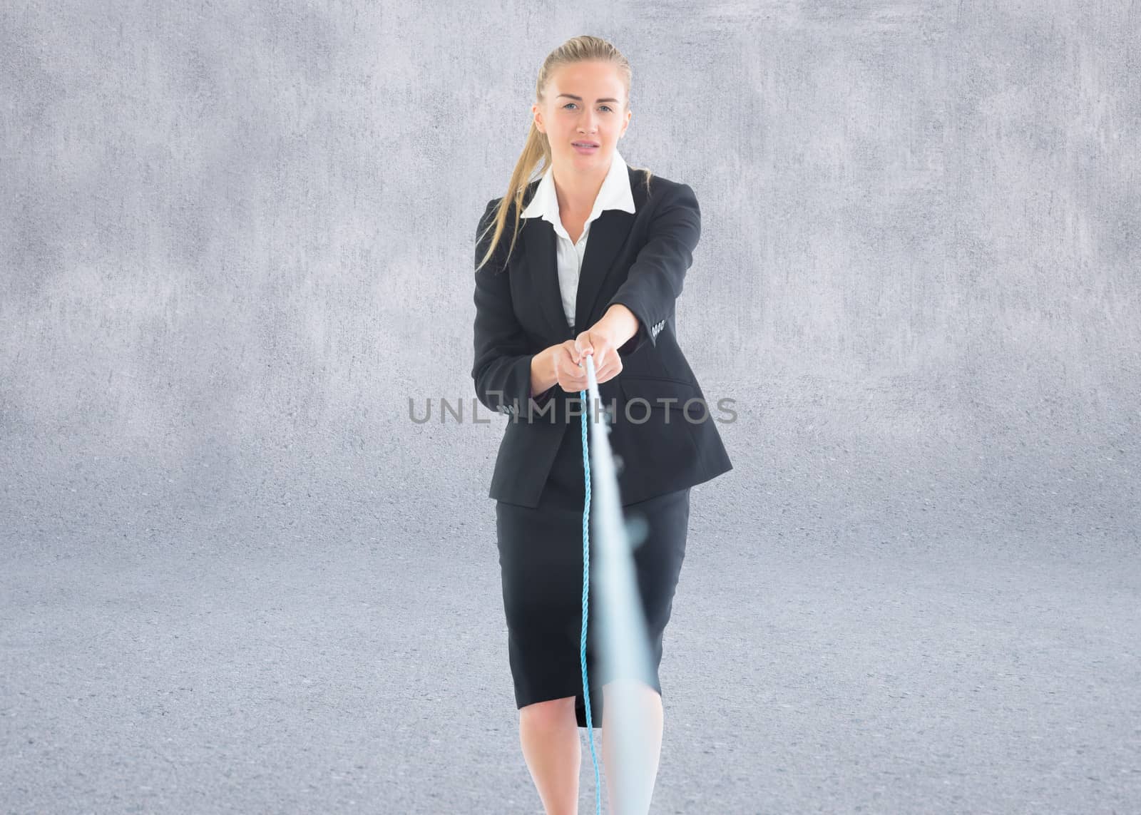 Composite image of businesswoman pulling a rope by Wavebreakmedia