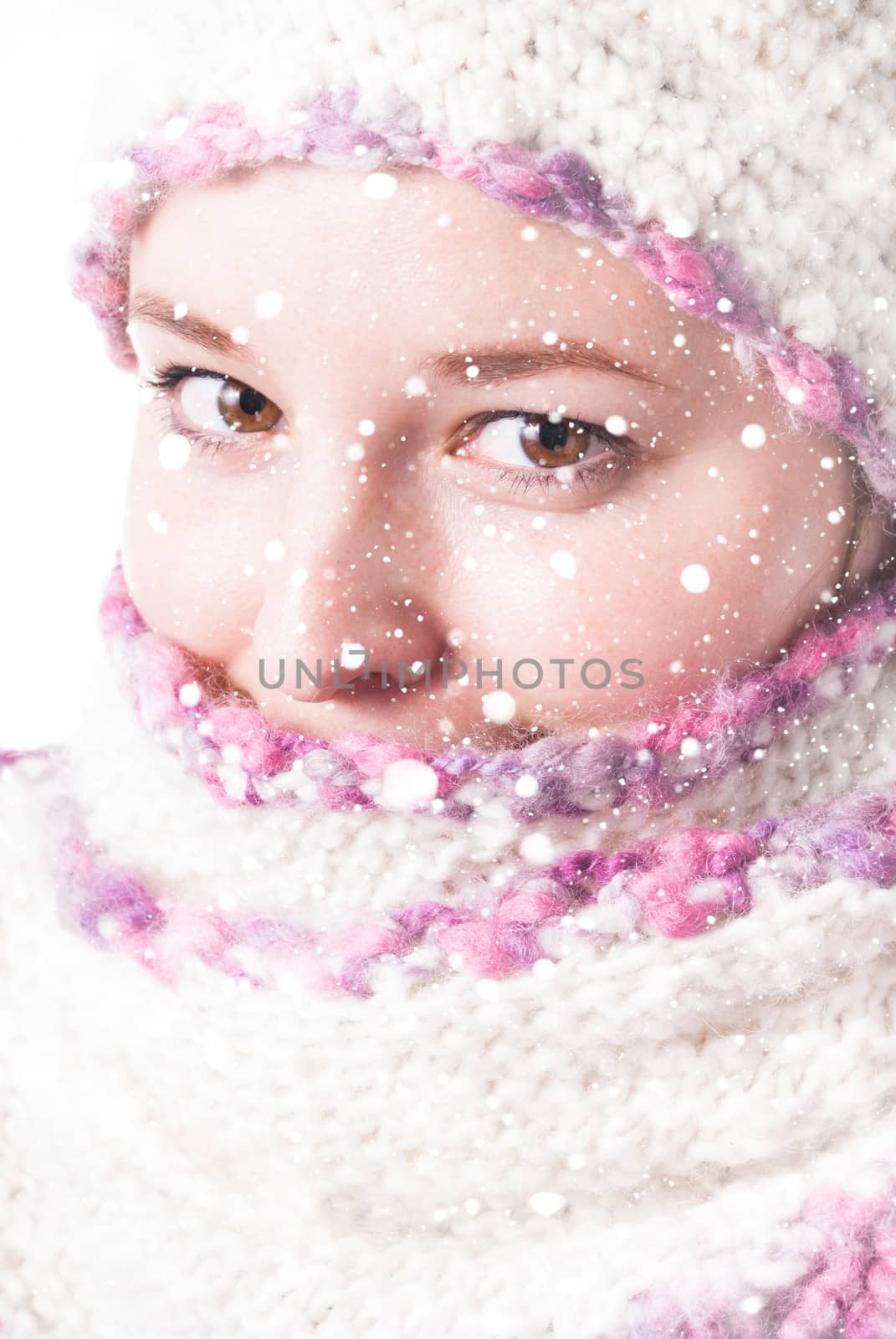 Close up woman's face wrapped in the scaf under the snowstorm