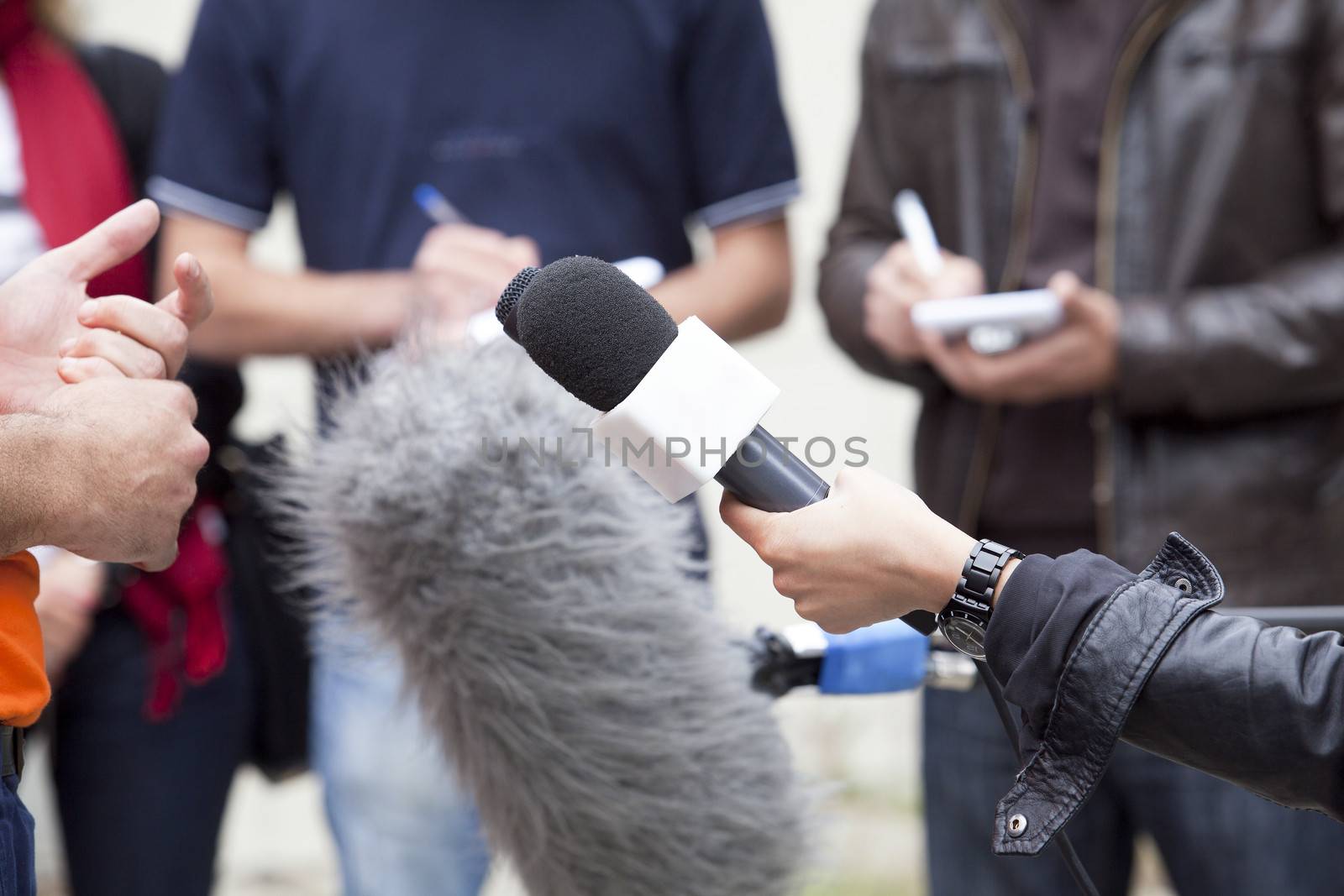 A journalist is making a interview with a microphone