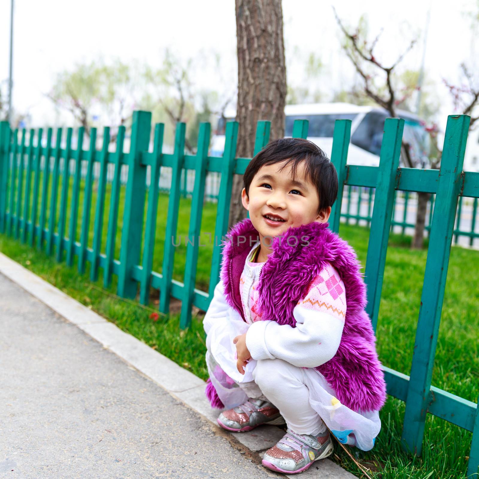 Adorable girl smiles in the street