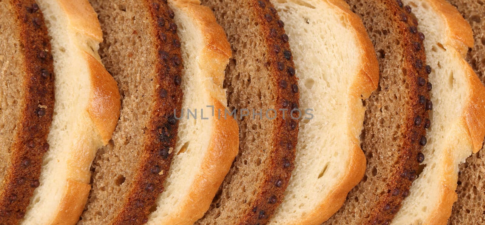 Sliced white and brown loaf of bread. by indigolotos