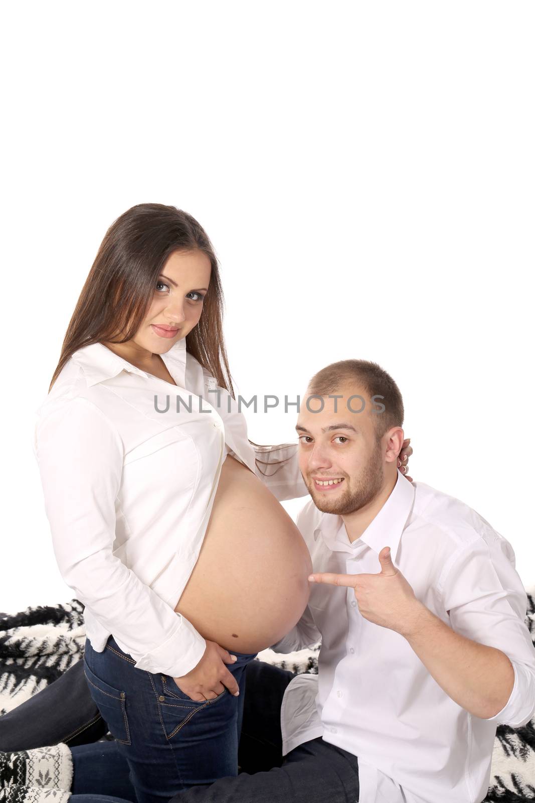 Happy men smiling with pregnant woman. by indigolotos