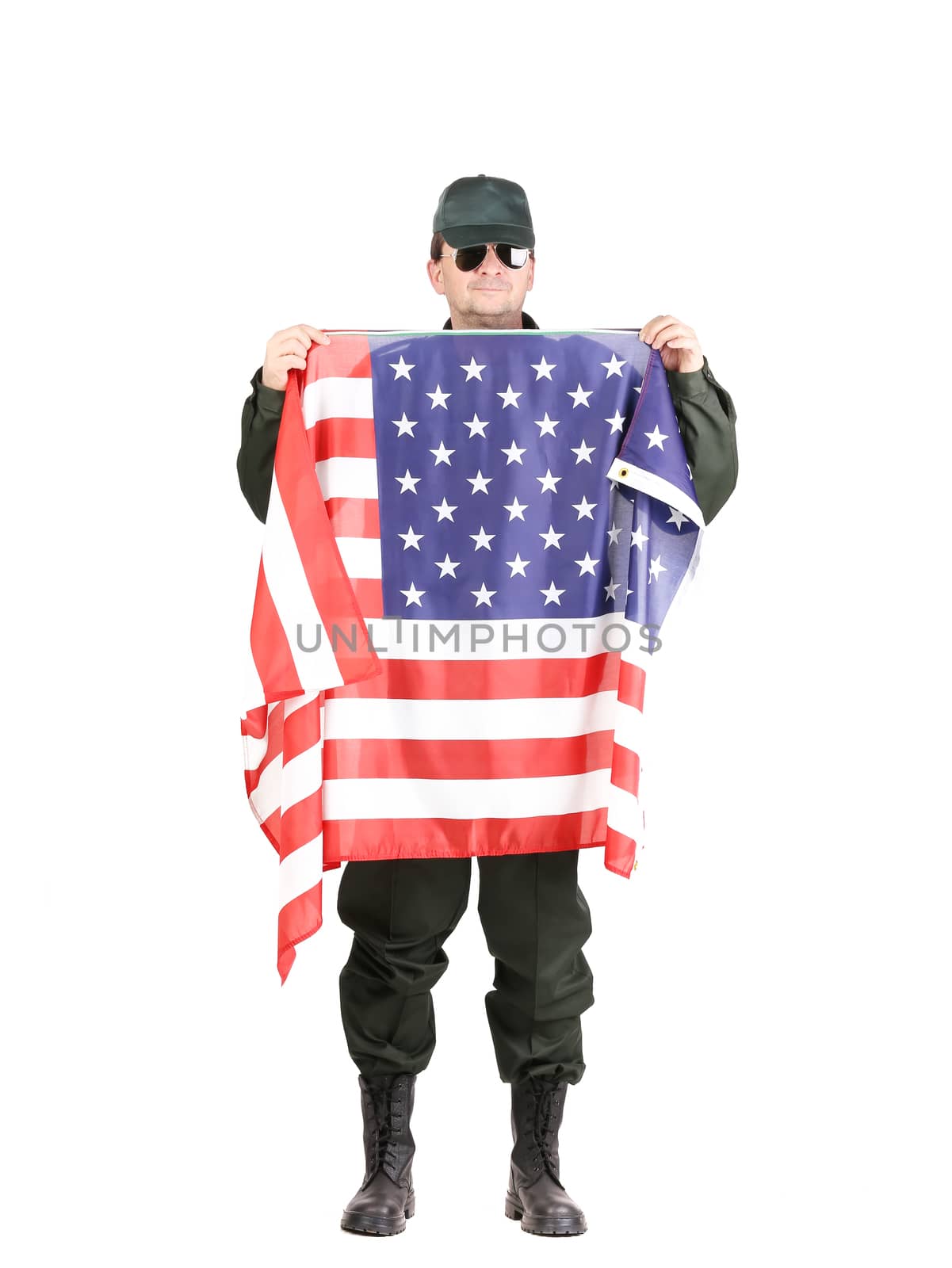 Man in workwear stands with american flag. Isolated on a white background.