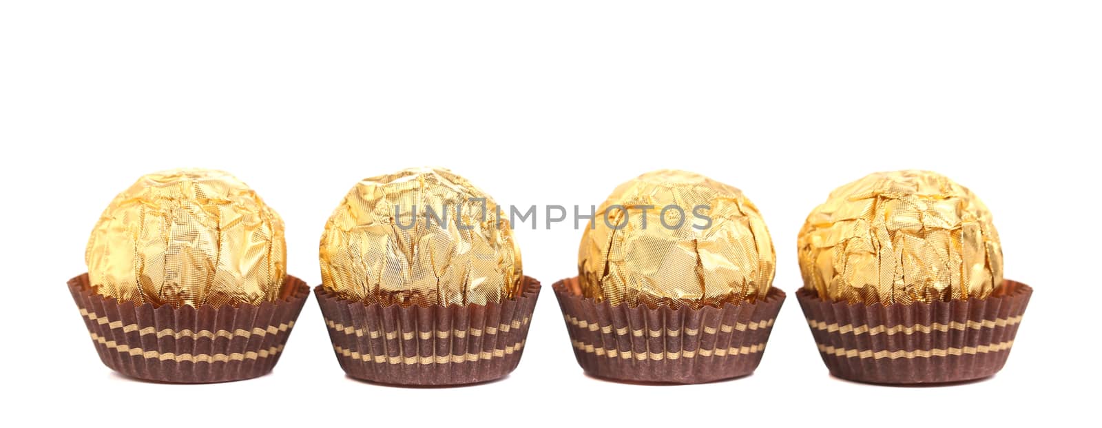 Four in row chocolate bonbons. Isolated on a white background.