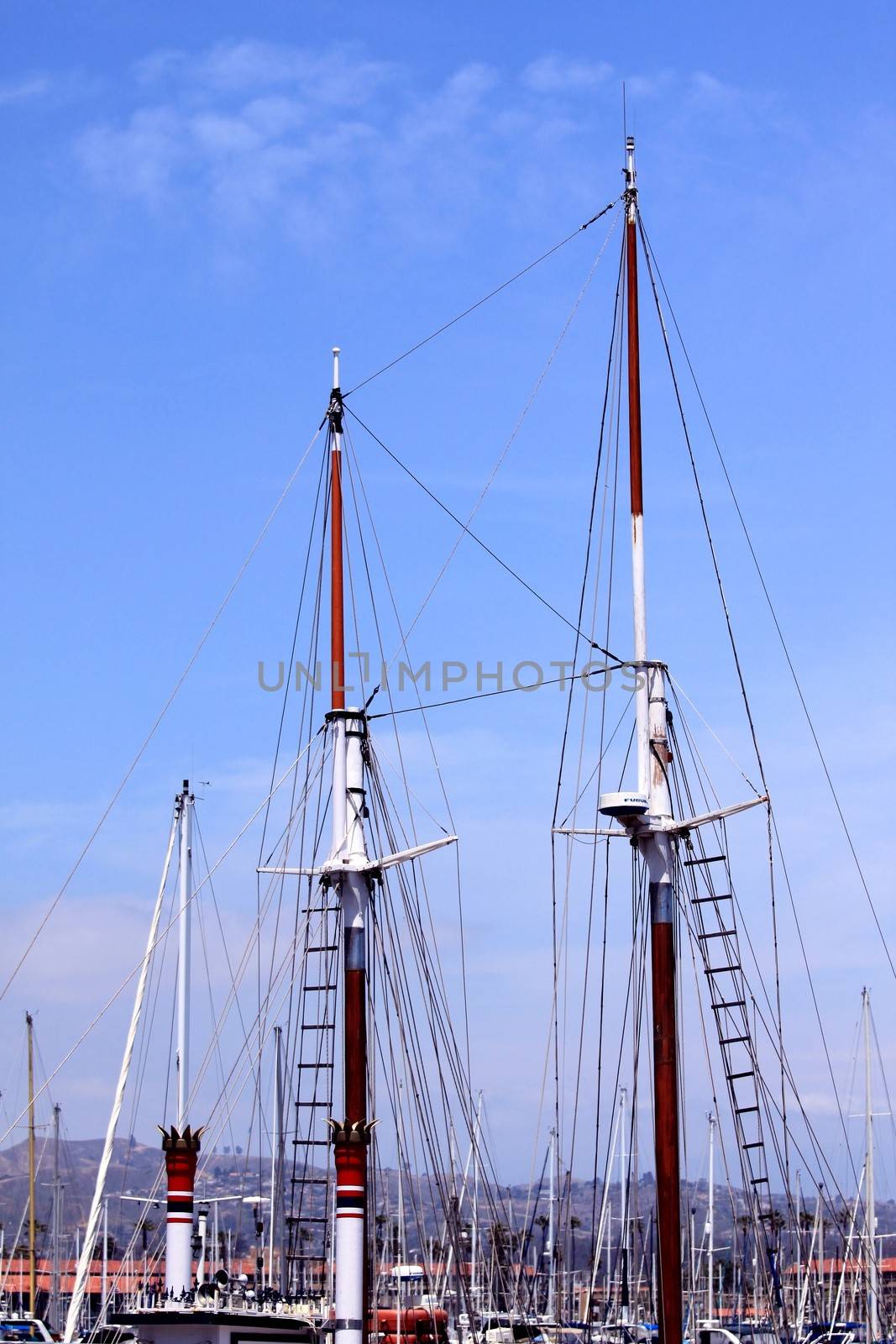 rigging of a sail boat with the blue sky in the background