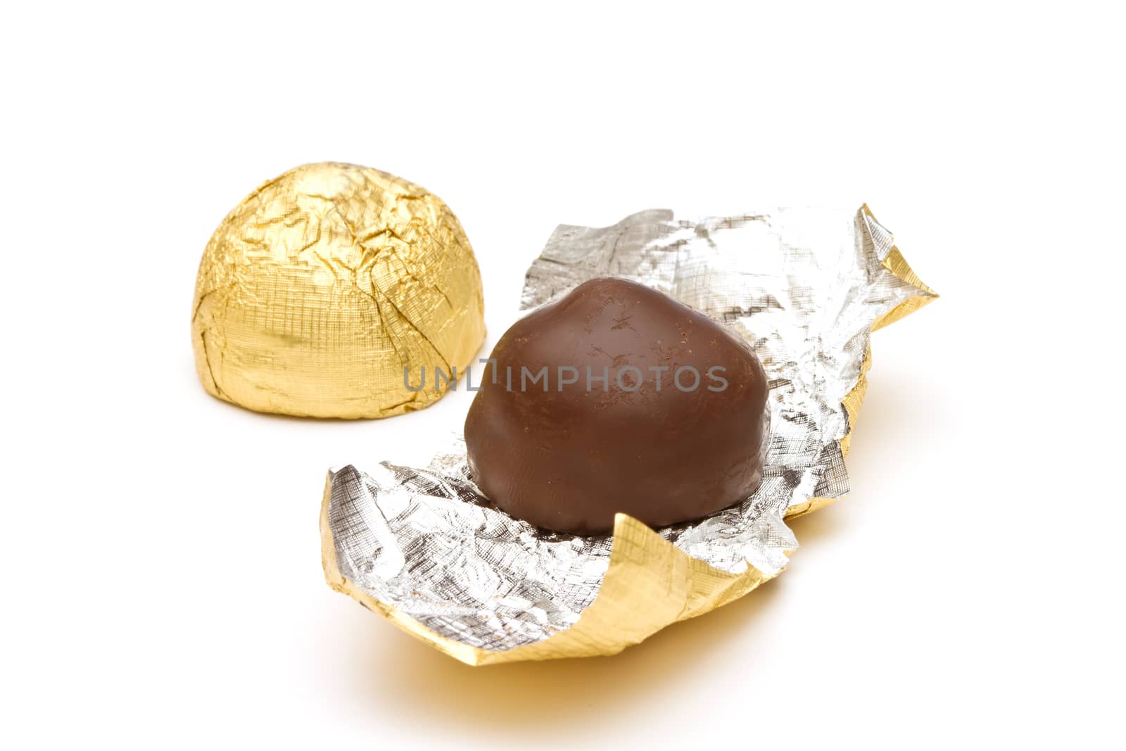 Chocolate pralines on white background