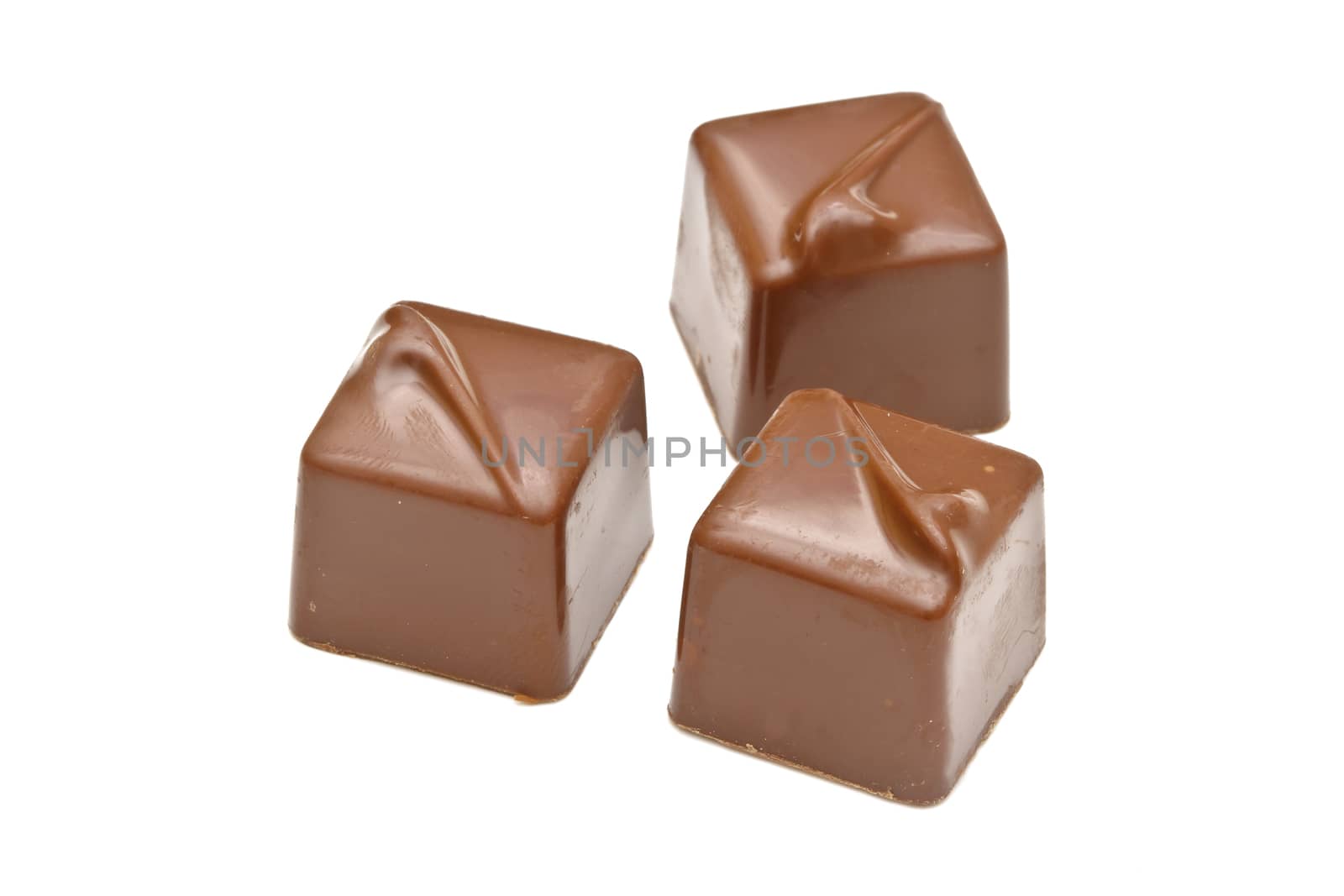 Chocolate pralines on white background