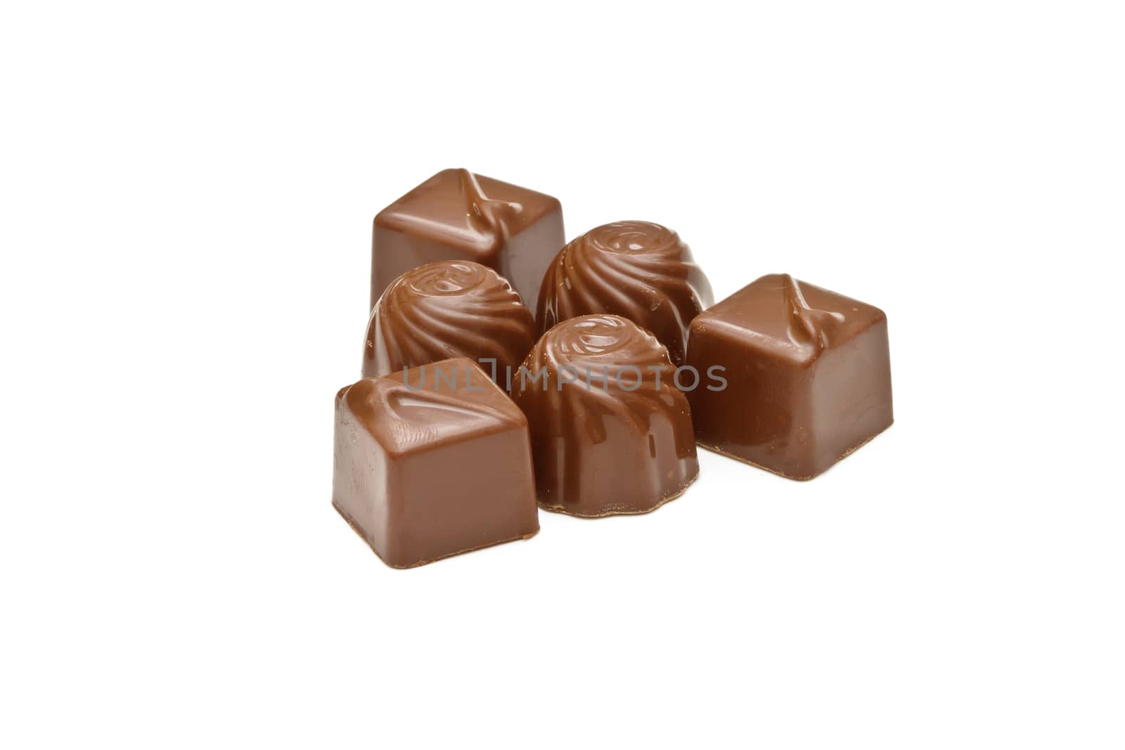 Chocolate pralines on white background