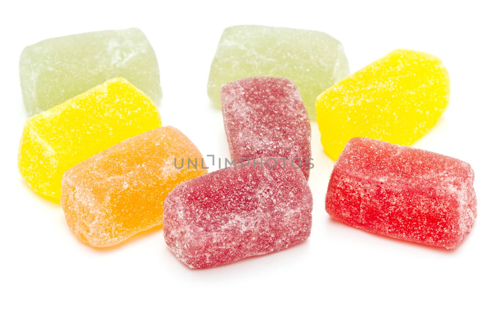 Different fruit jellies on white background