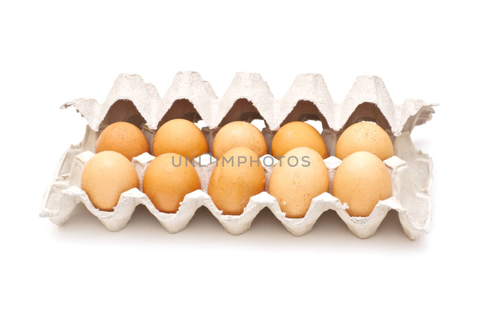 Brown eggs in a carton package on white background