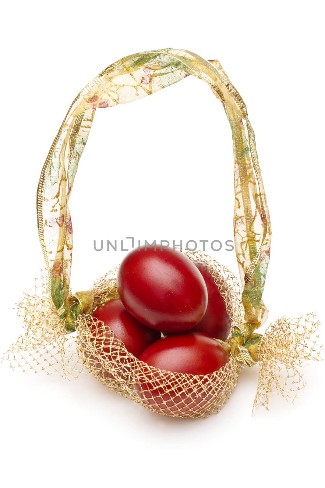 Red easter eggs in decorative basket, isolated on white