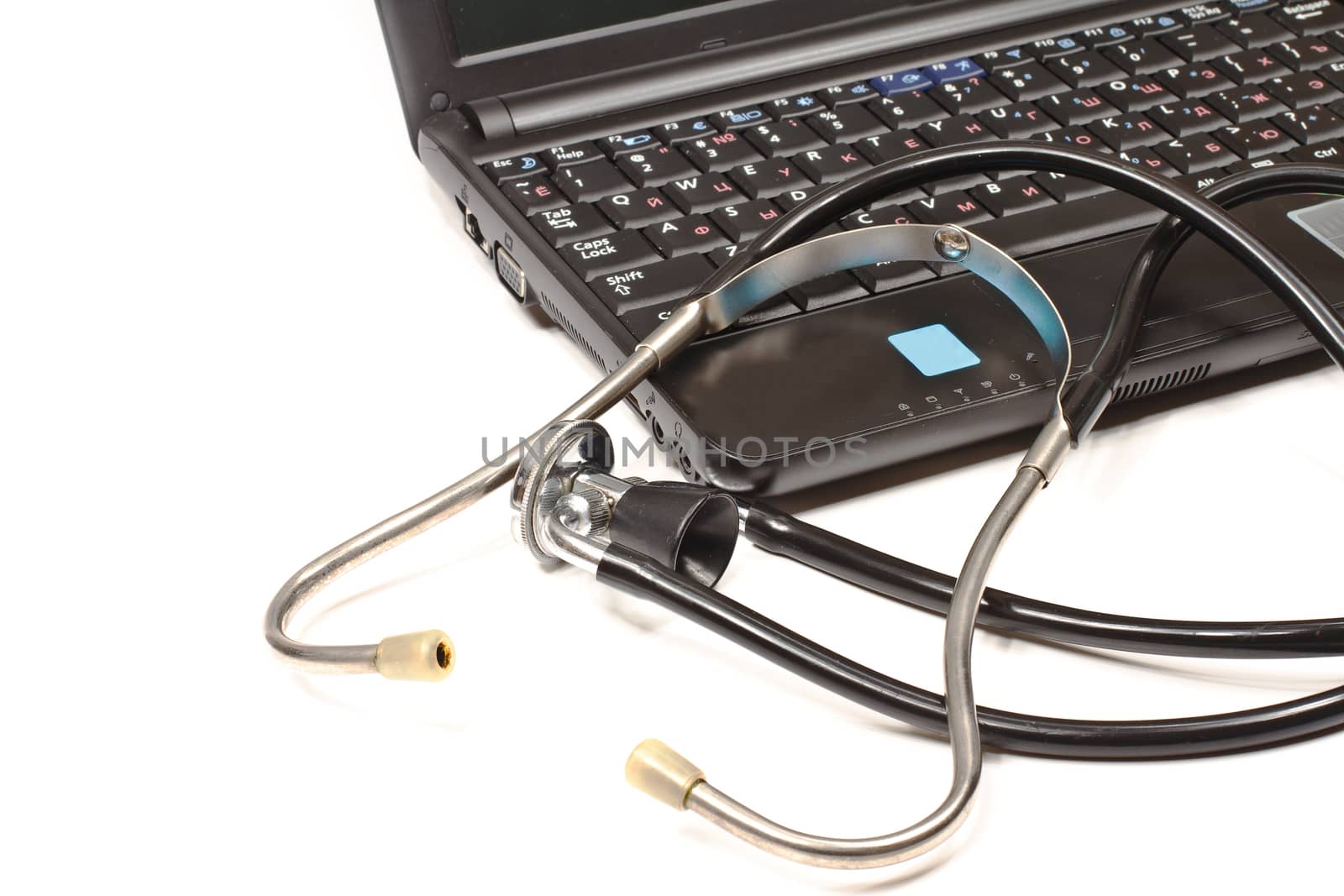 Stethoscope and laptop isolated on white background