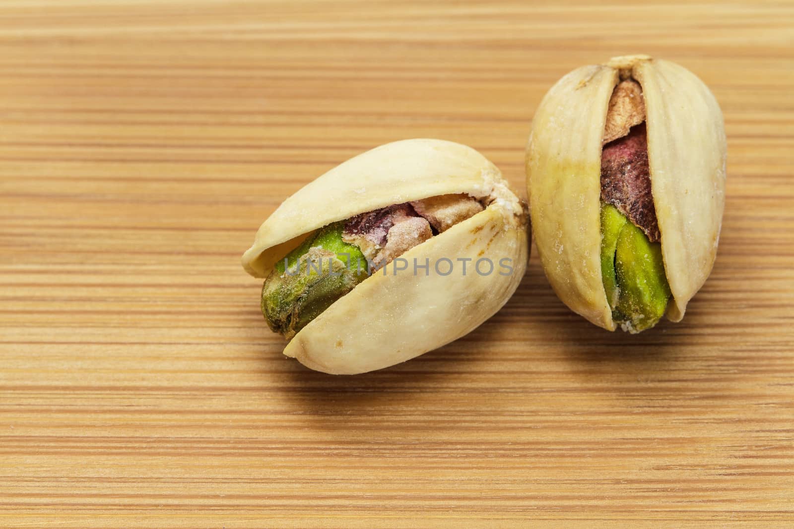 Pistachio nuts on wooden board