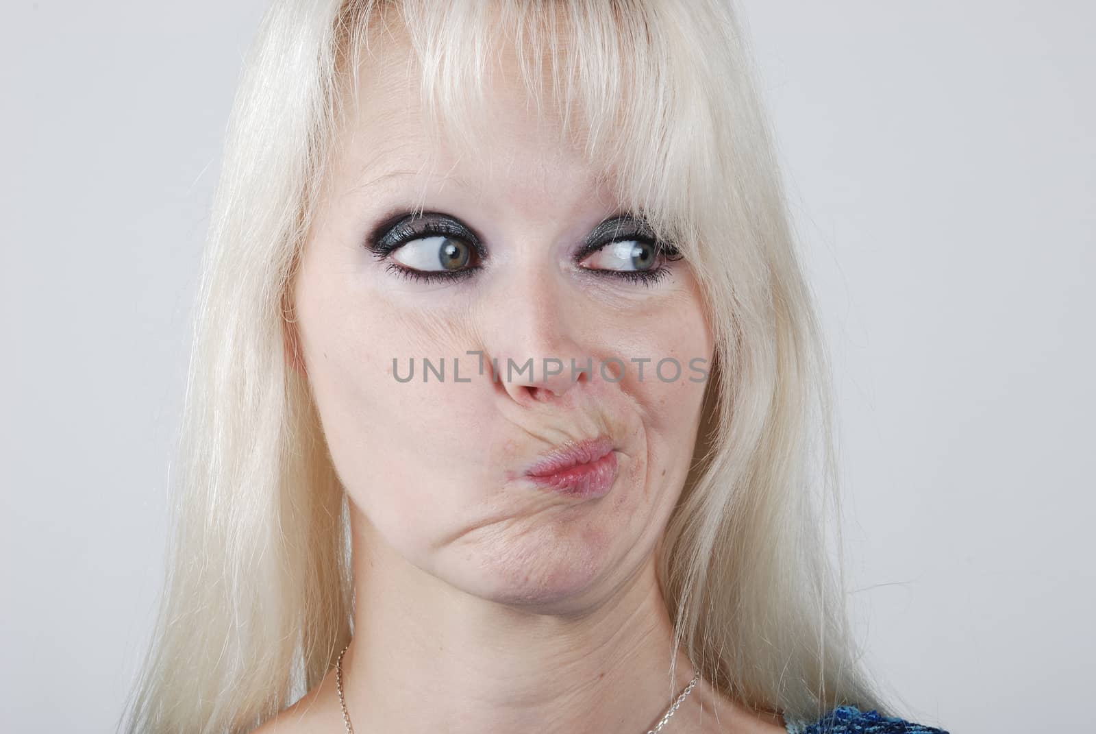 Young blond  woman making a face