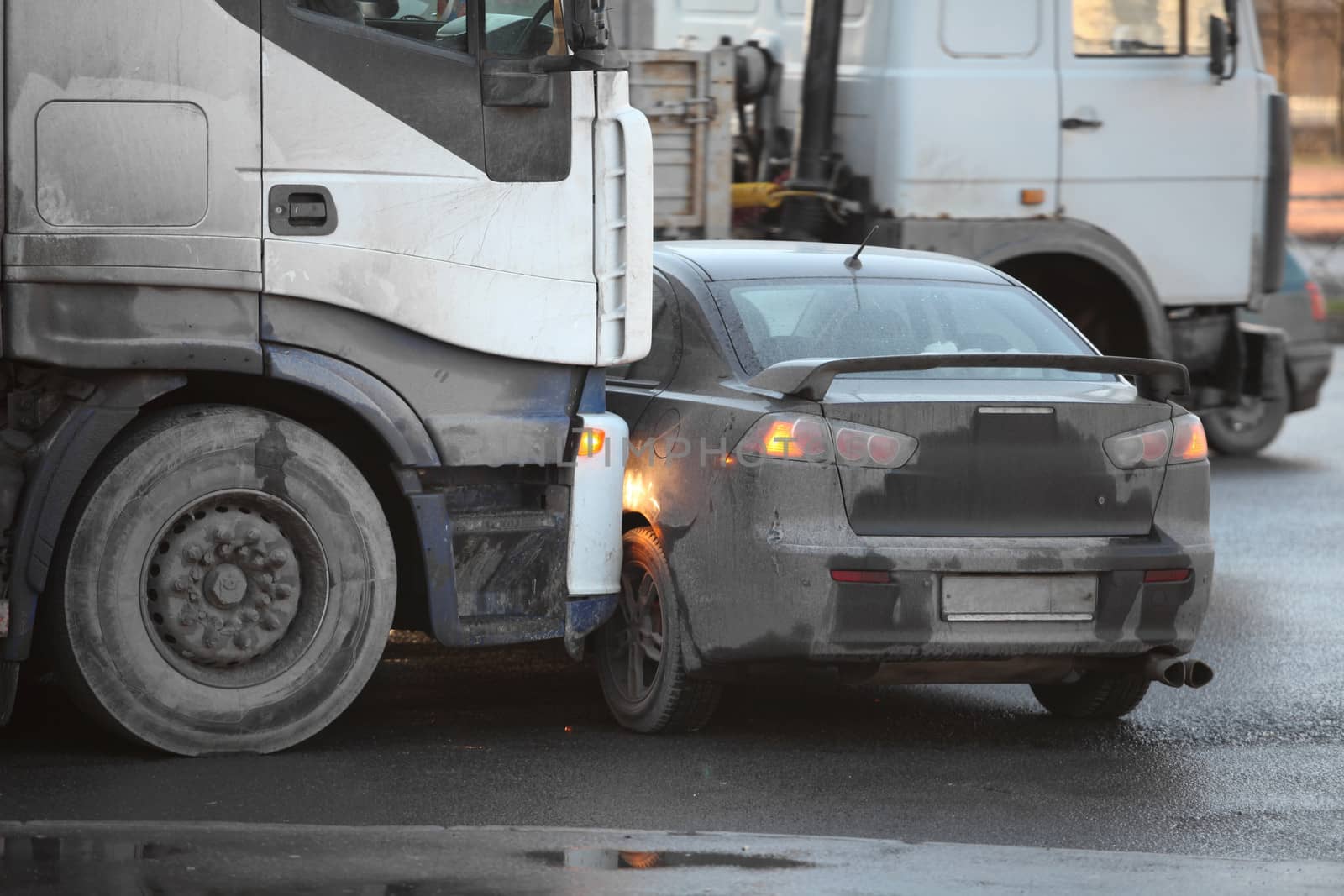 collision of the truck and car on a busy road side view
