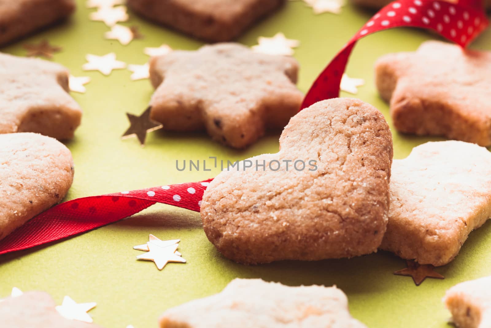 Christmas cookies with red ribbon on green