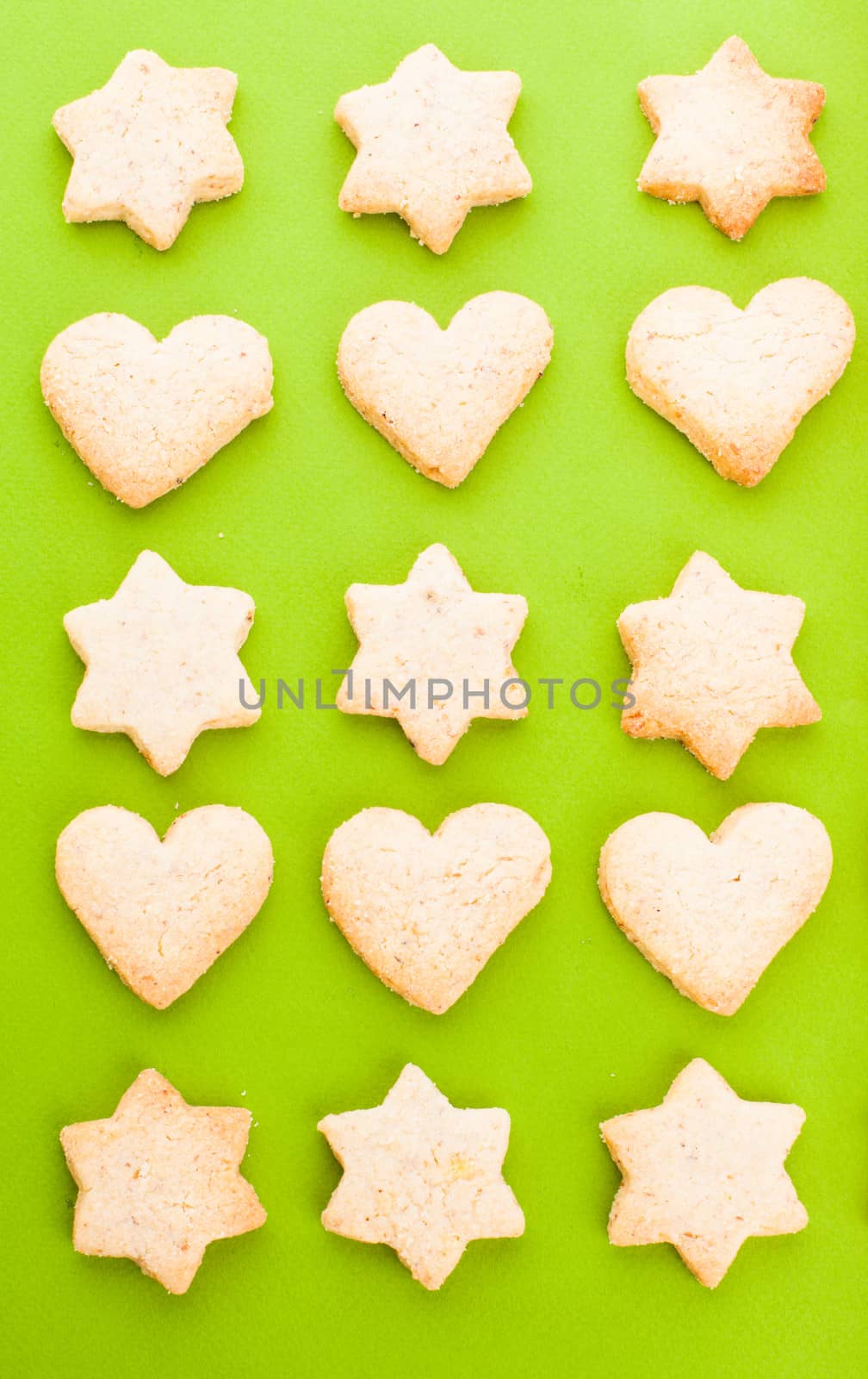 Holiday cookies as a background pattern on green