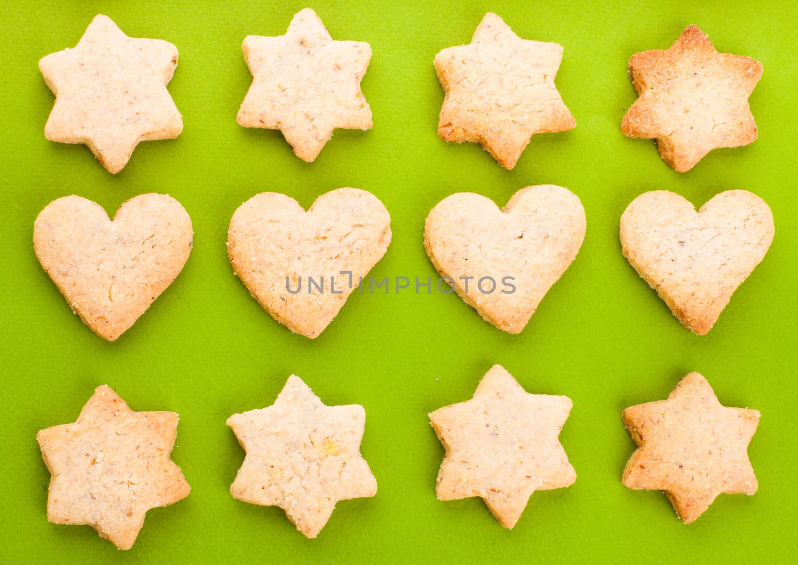 Holiday cookies as a background pattern on green