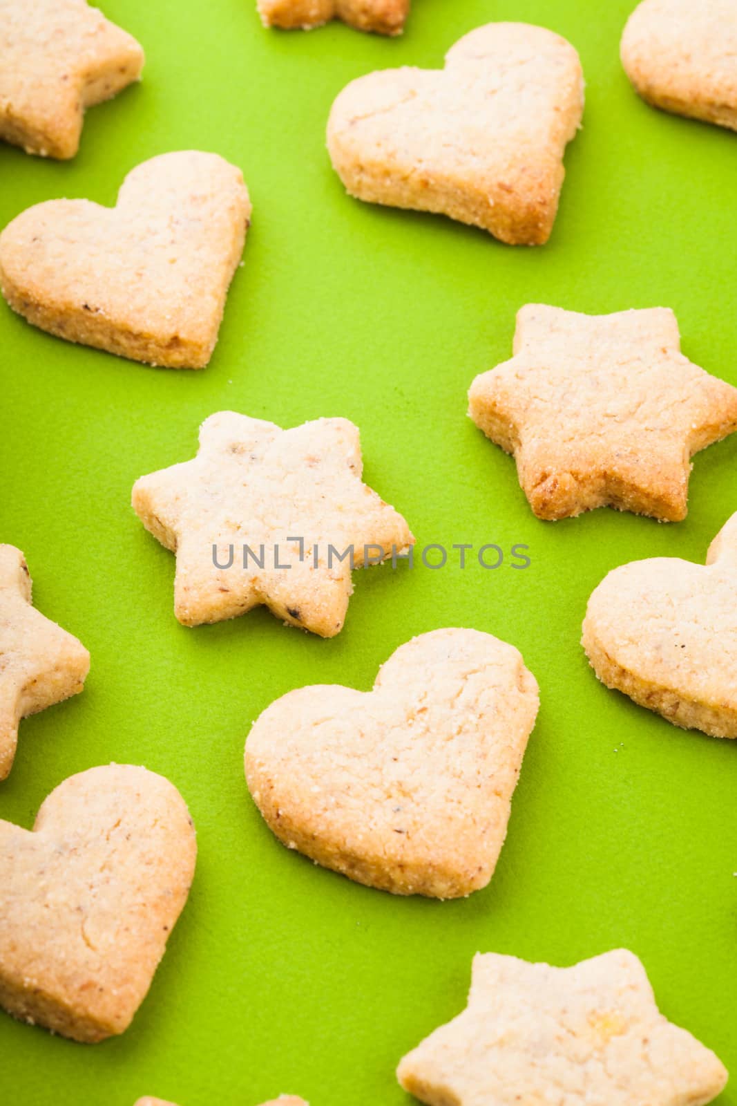 Holiday cookies as a background pattern on green