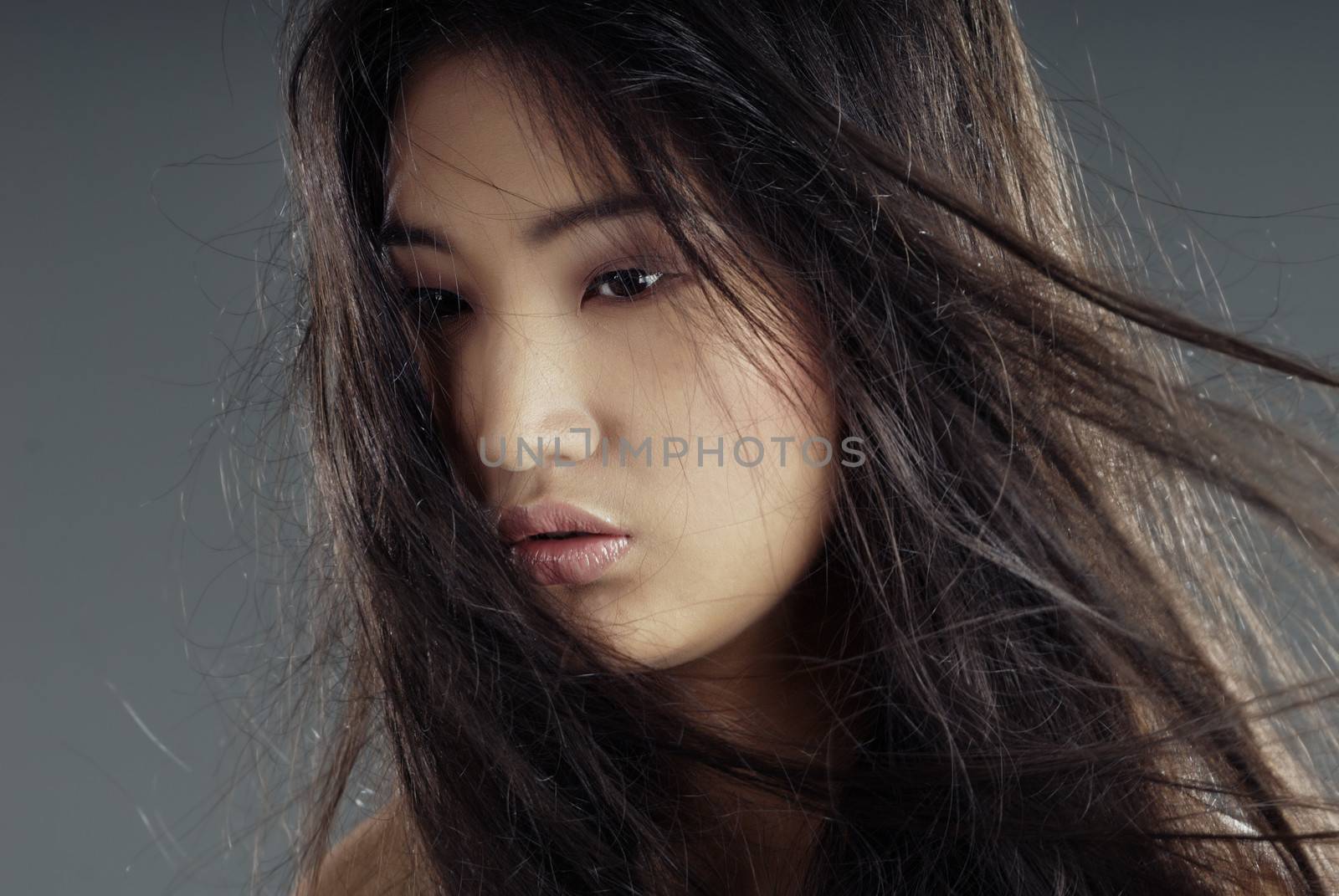 Close-up portrait of the young Asian lady with long hairs