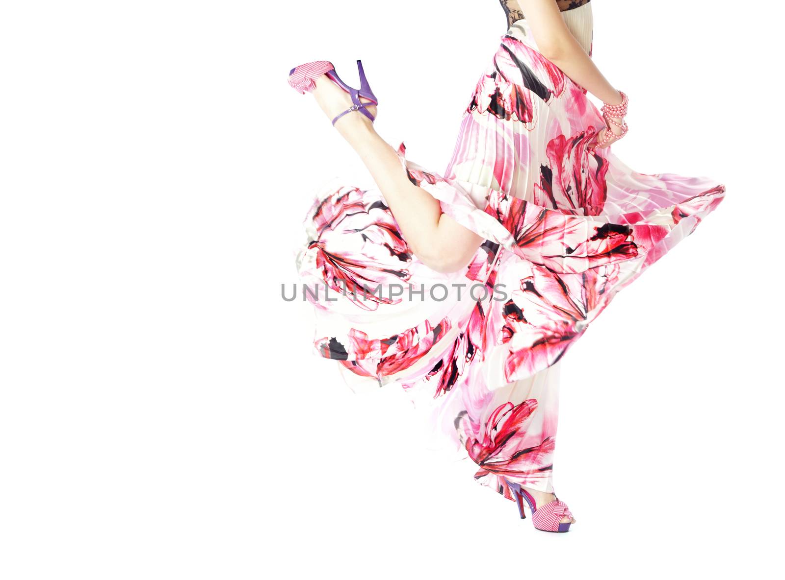 Body part of the woman dancing in stylish pink dress