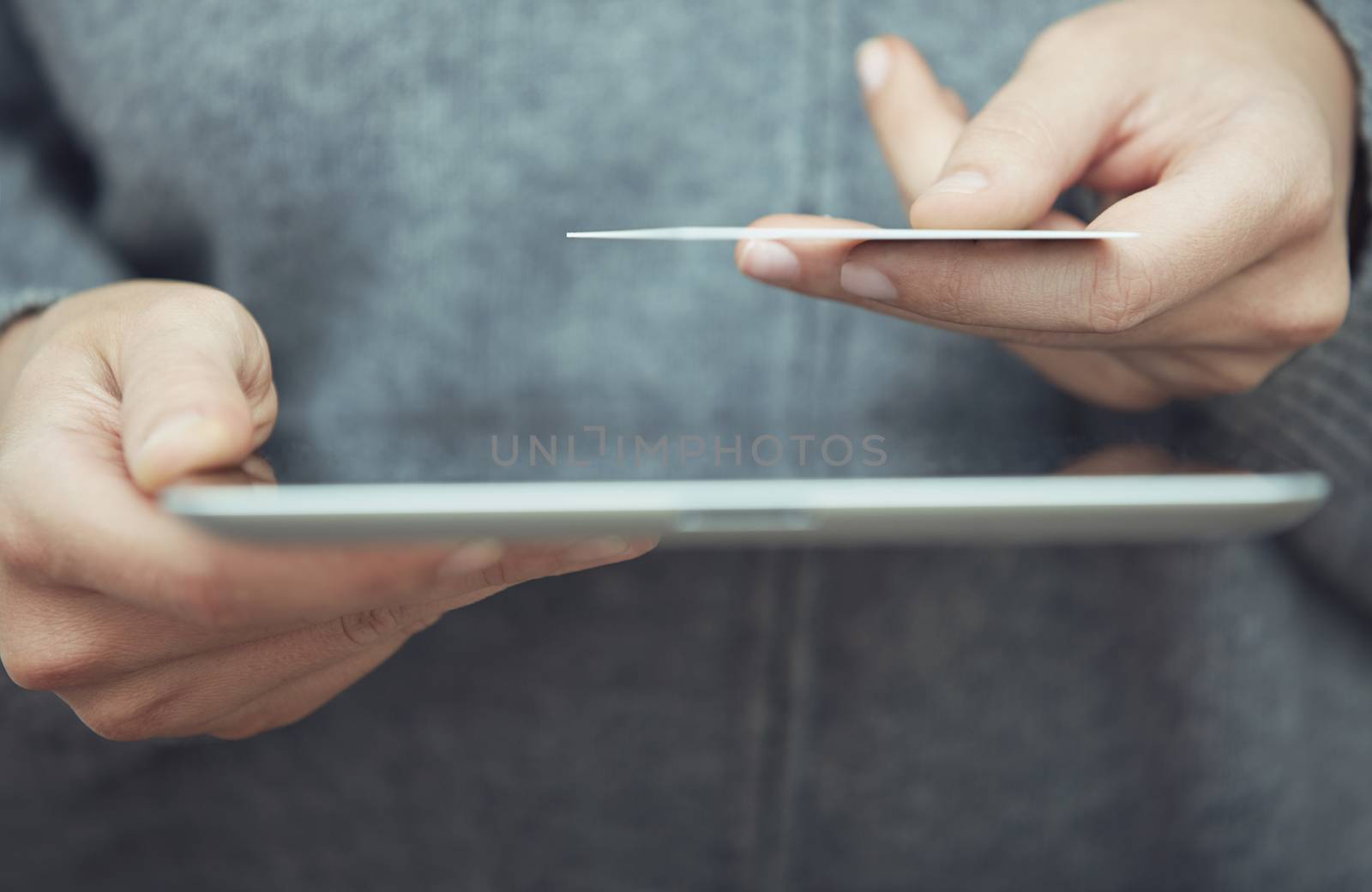 Woman with digital tablet and credit card. Close-up view