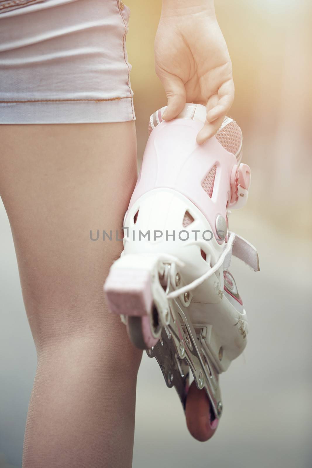 Close-up view on teenager holding roller skate