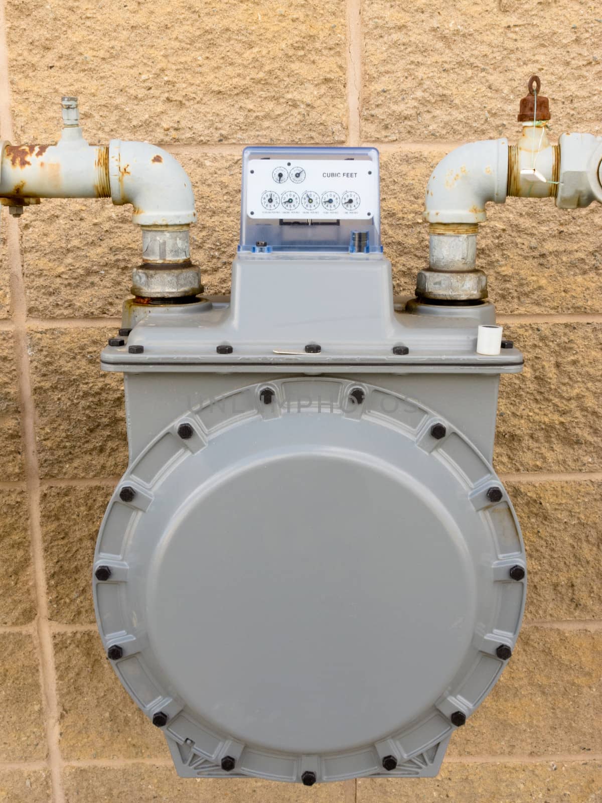 Residential natural gas meter on exterior wall to measure household energy consumption