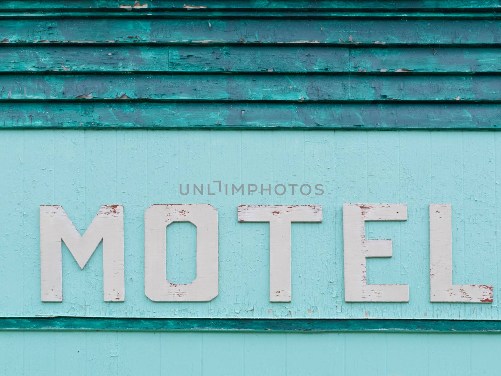 Painted blue-green historic motel facade siding by PiLens