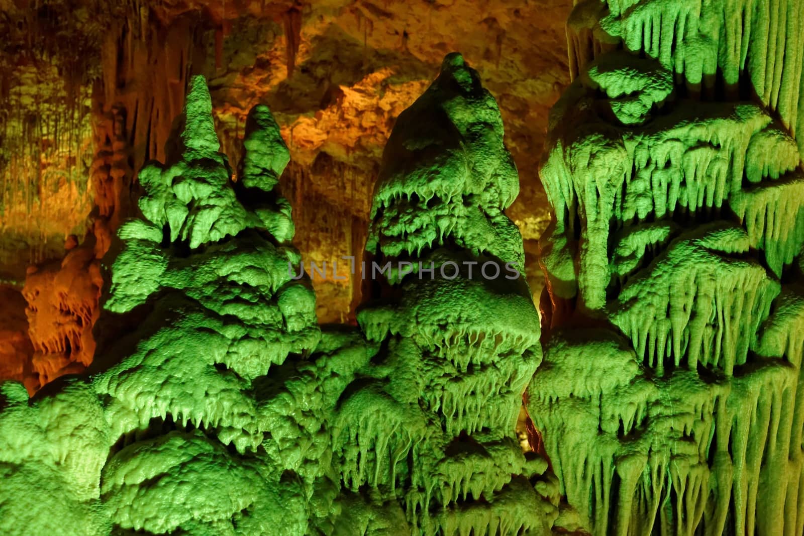 Strange green-lit stalagmite shapes in Soreq Cave, Israel