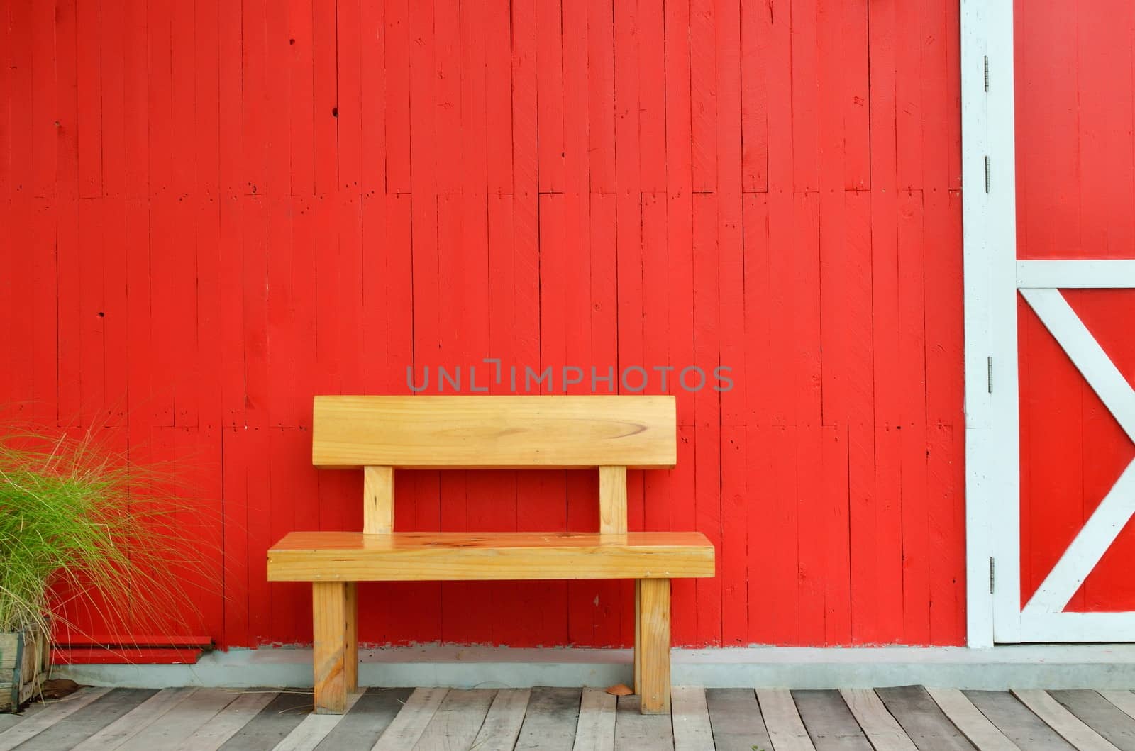 wood bench and red wall