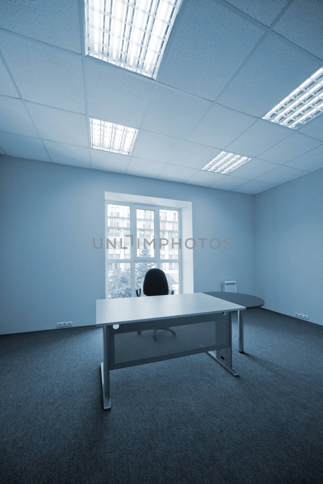 Chair and desk at a window at modern office