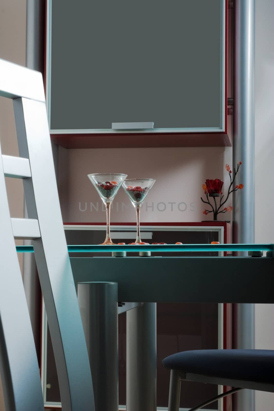 two wine glasses on a glass table in kitchen