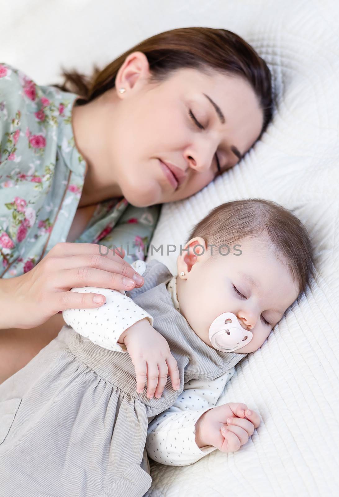Young mother and her baby girl sleeping in the bed by doble.d