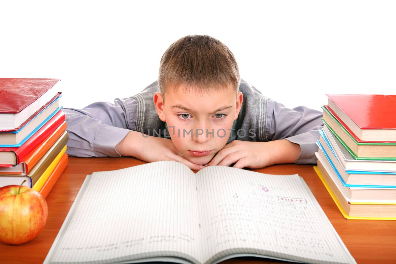 Bored and Tired Boy on the School Desk Isolated on the white background
