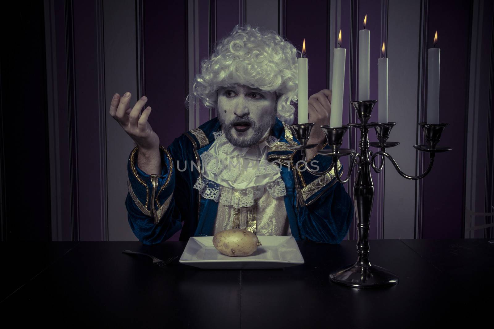 Eating, man dressed in rococo style, concept of wealth and pover by FernandoCortes