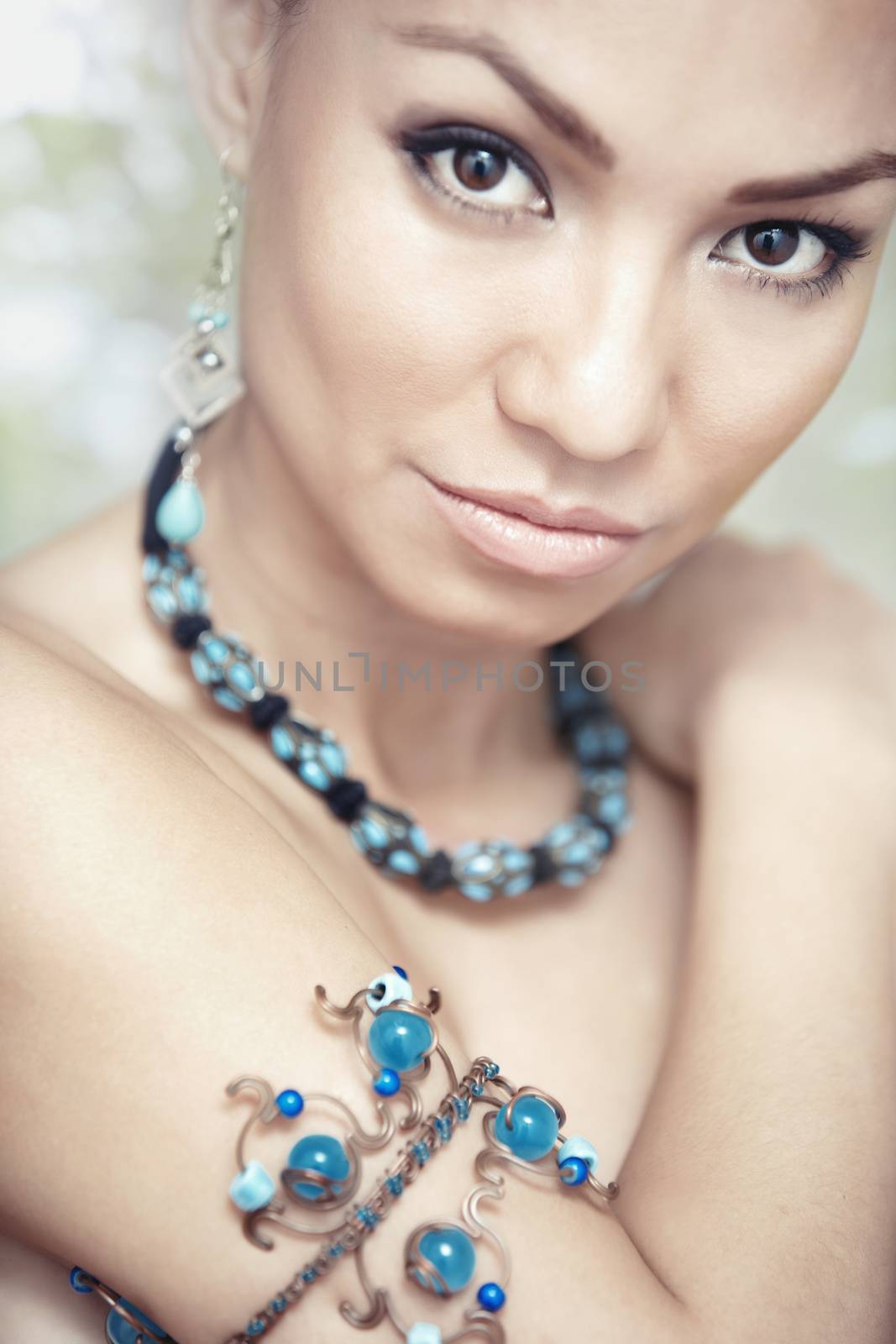 Woman with blue jewelry by Novic