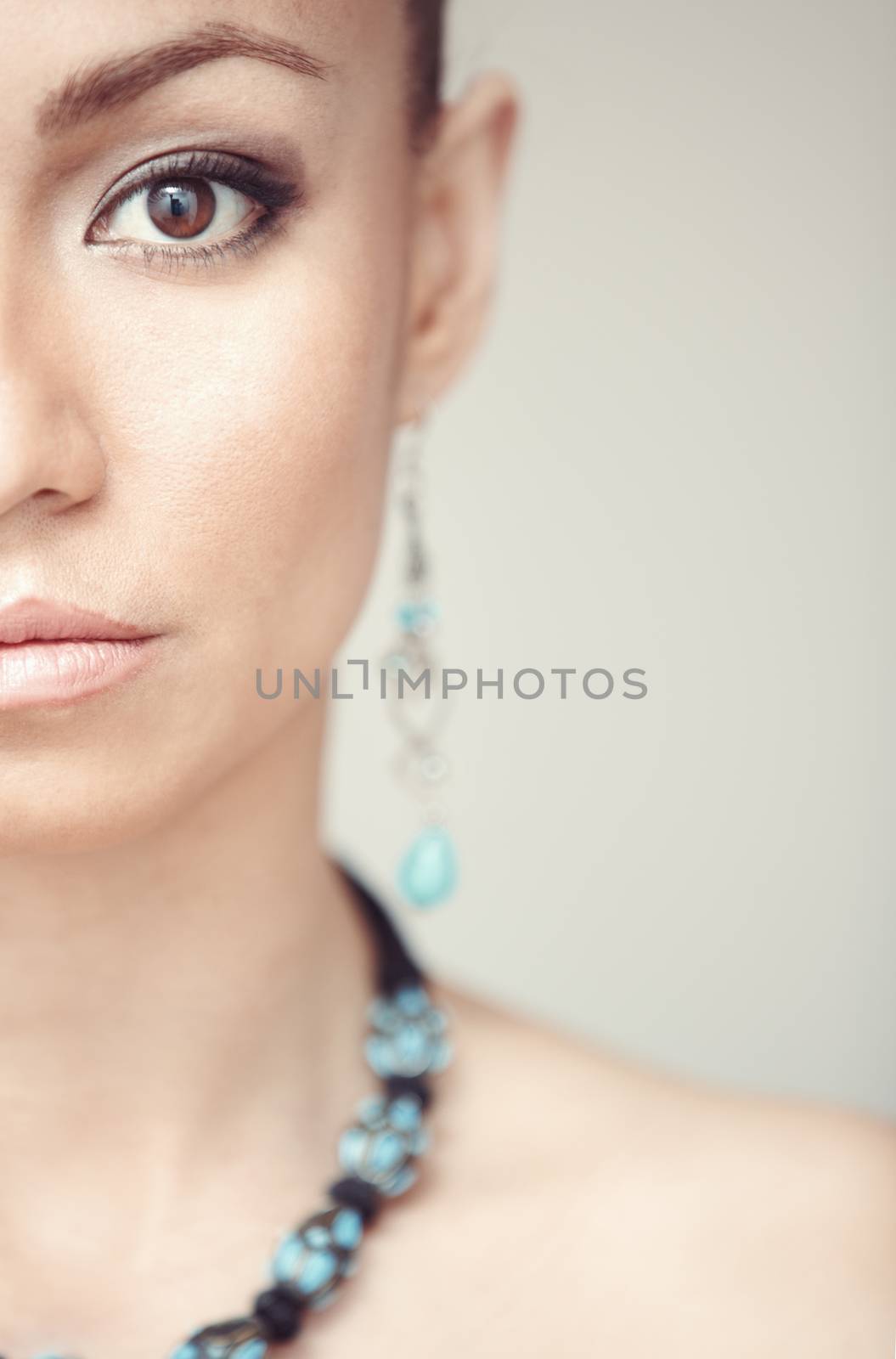 Woman with blue jewelry. Vertical photo