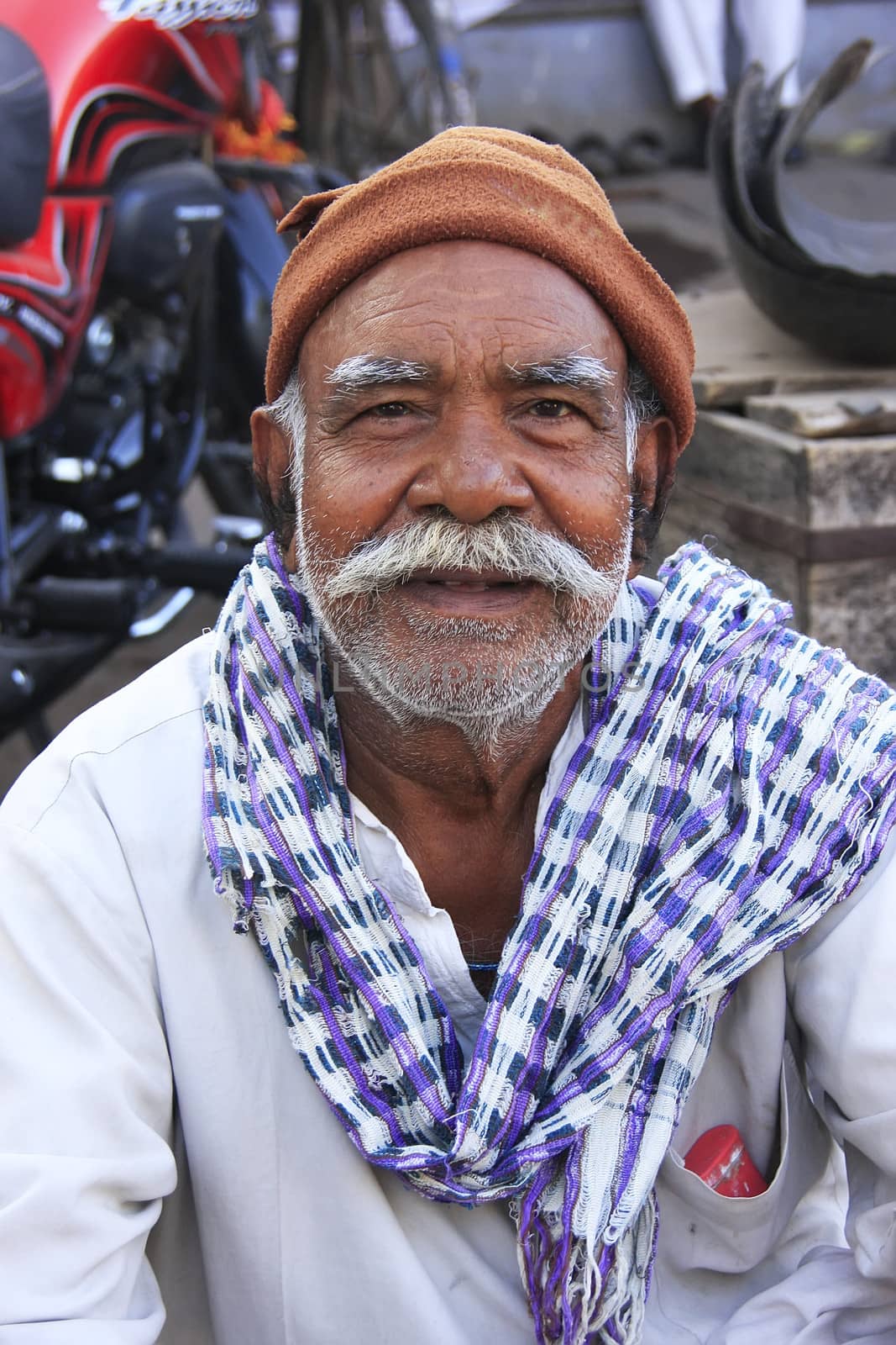 Indian man sitting at the market, Bundi, India by donya_nedomam