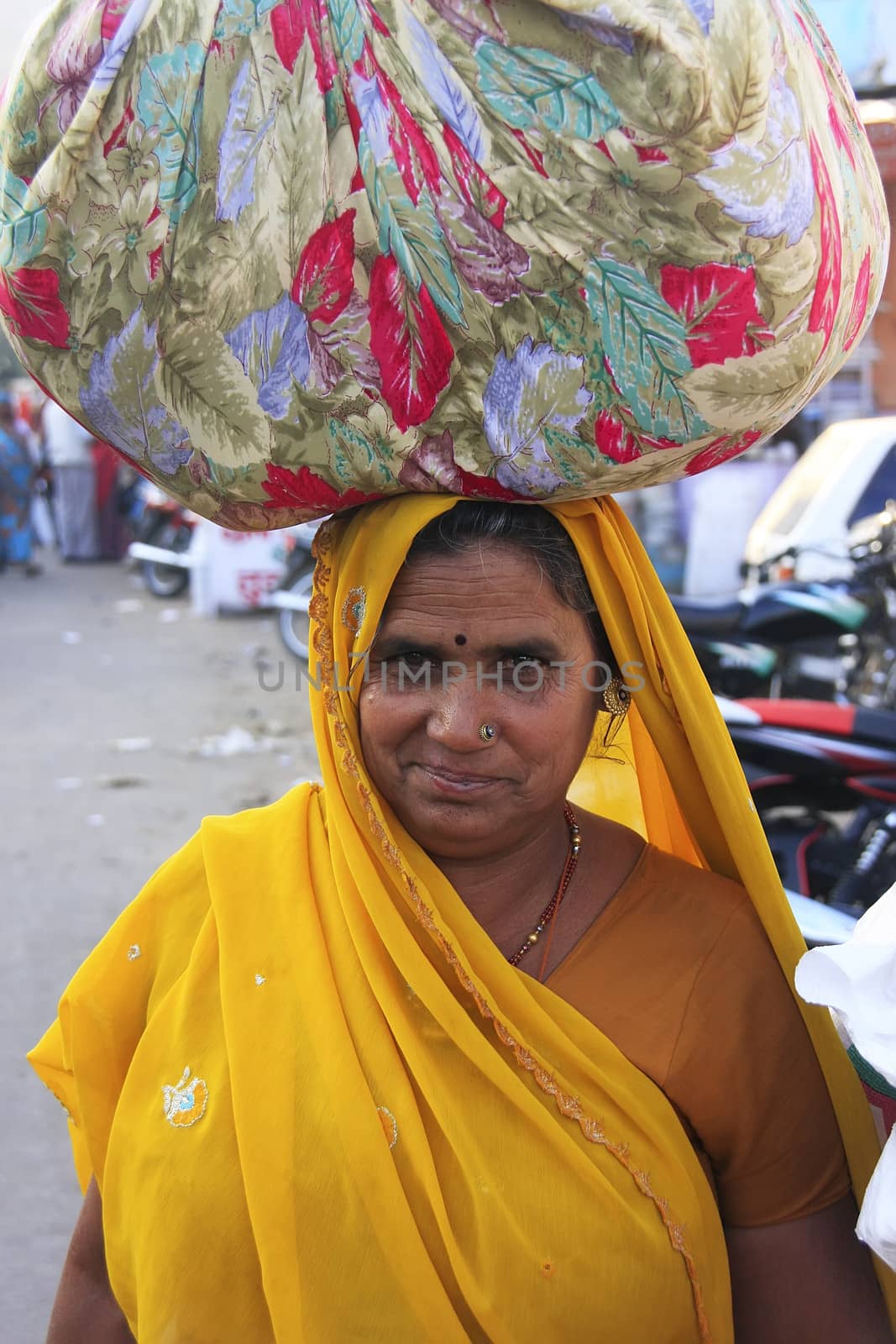 Indian woman carrying bundle on her head, Bundi, Rajasthan, India