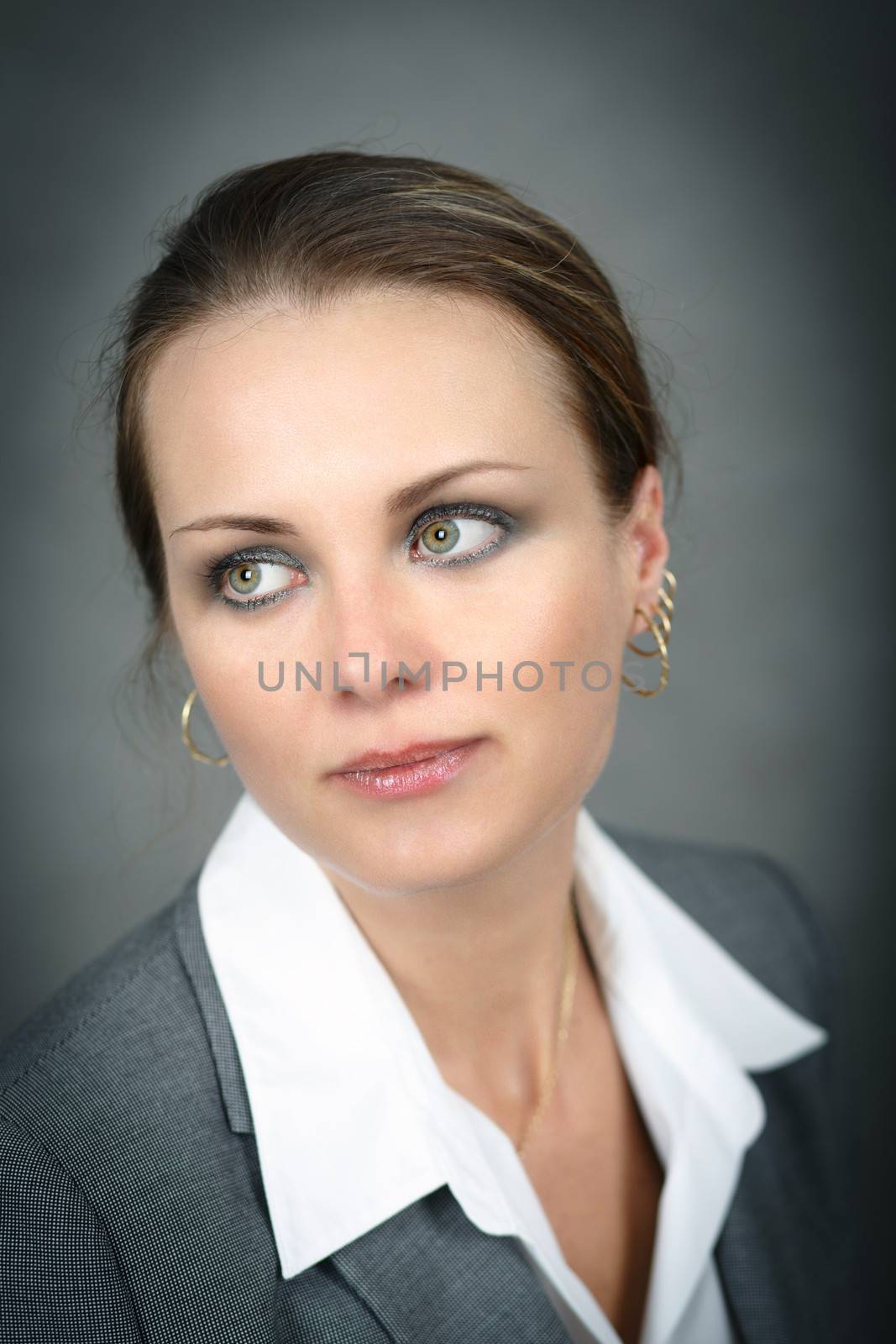 Portrait of middle age business woman on grey background with shallow focus