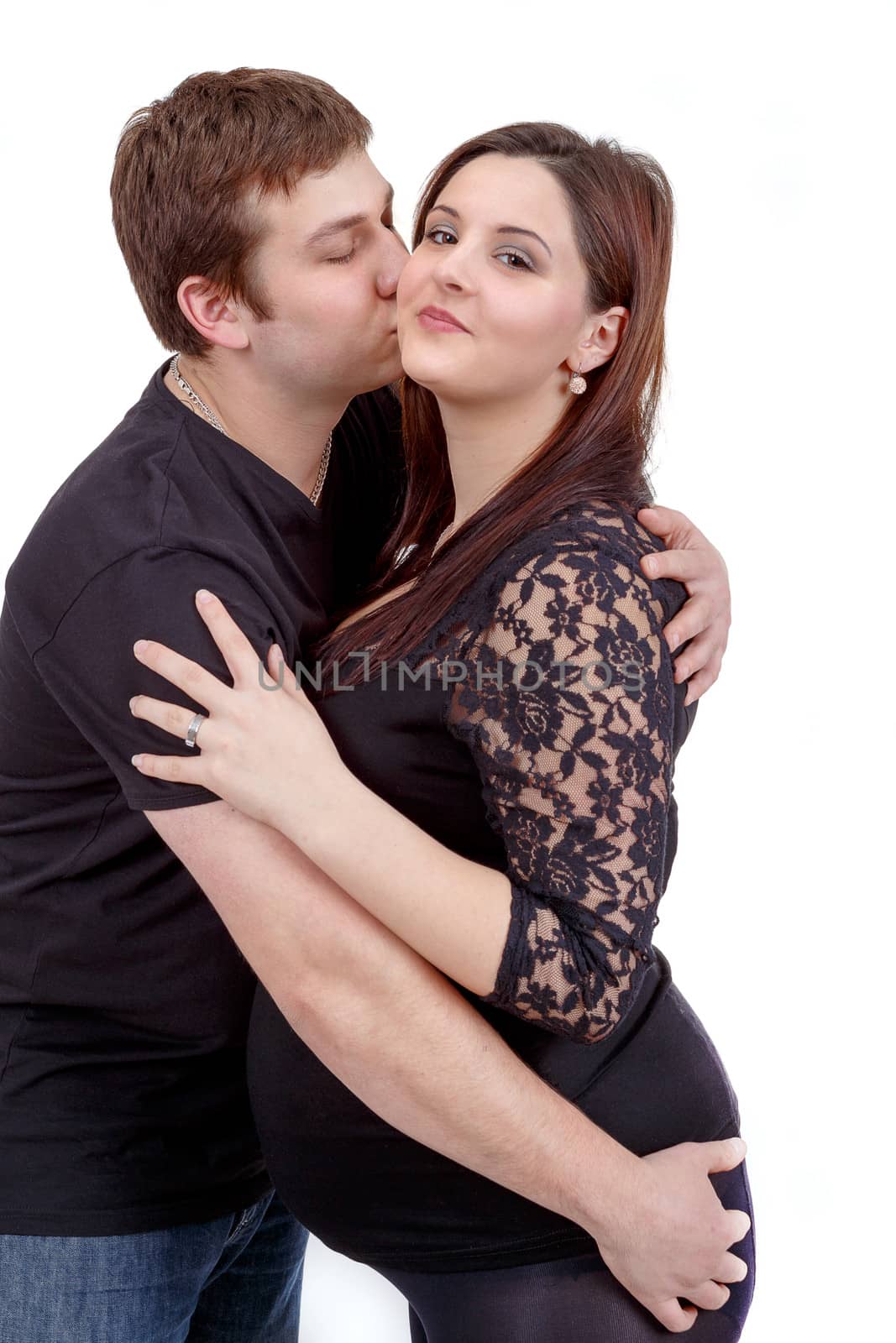 loving happy couple, pregnant woman with her husband, husband kissing woman isolated on white background