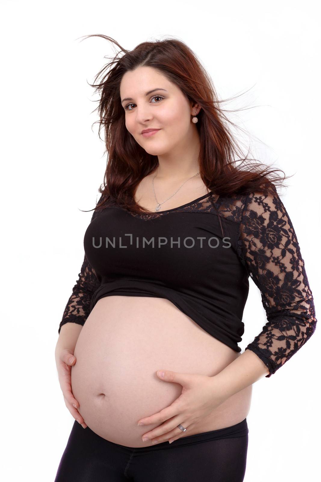 beautiful smiling pregnant woman tenderly holding her tummy isolated on white background