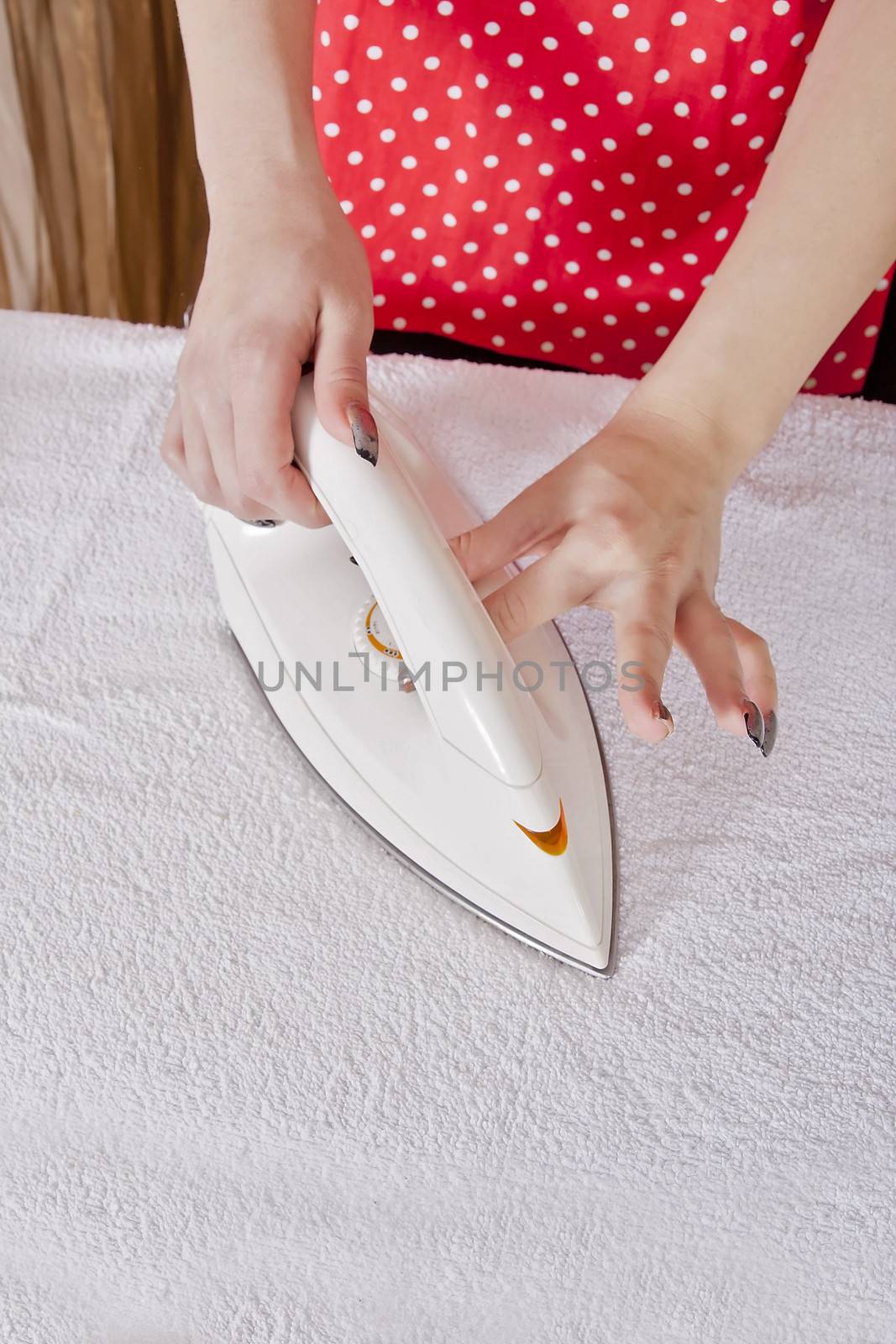 Female hand ironing clothes by dukibu