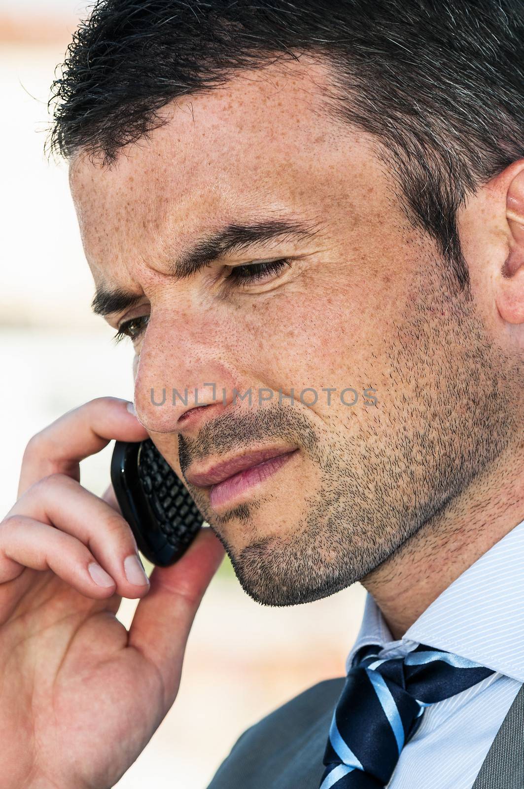 businessman is having a communication with his cellphone