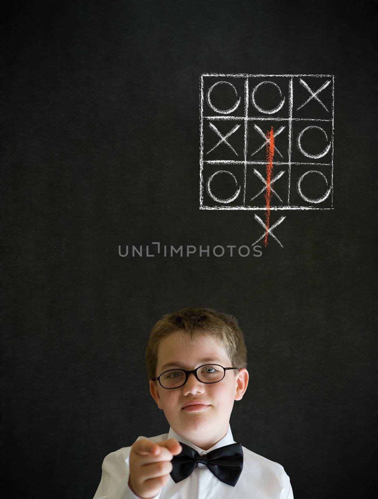 Education needs you thinking boy dressed up as business man with thinking out of the box tic tac toe concept on blackboard background