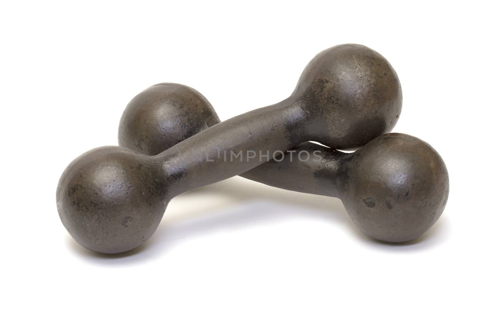 Old rusty iron dumbbells on white background