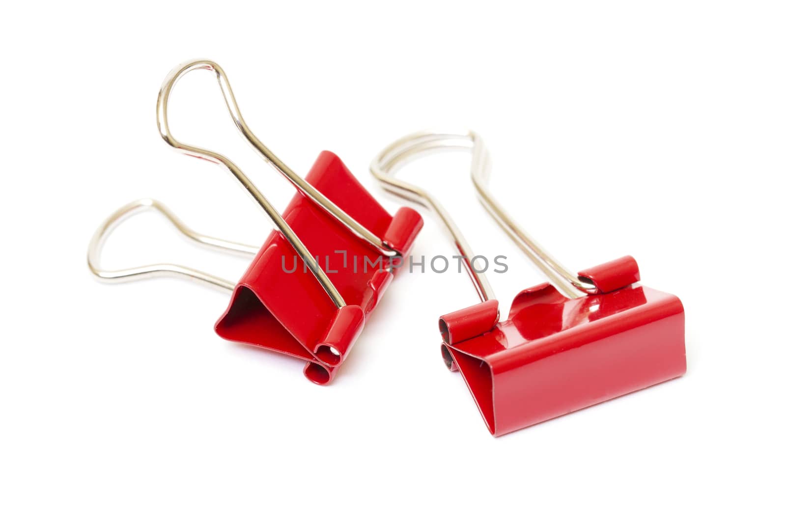 Red paper clips closeup on white