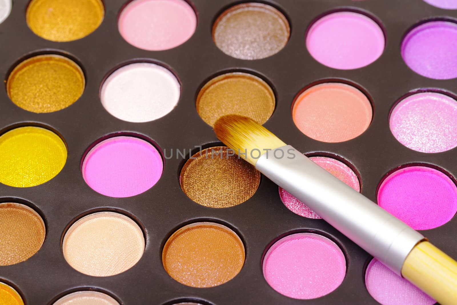 Set of multicolored eyeshadows with makeup brush