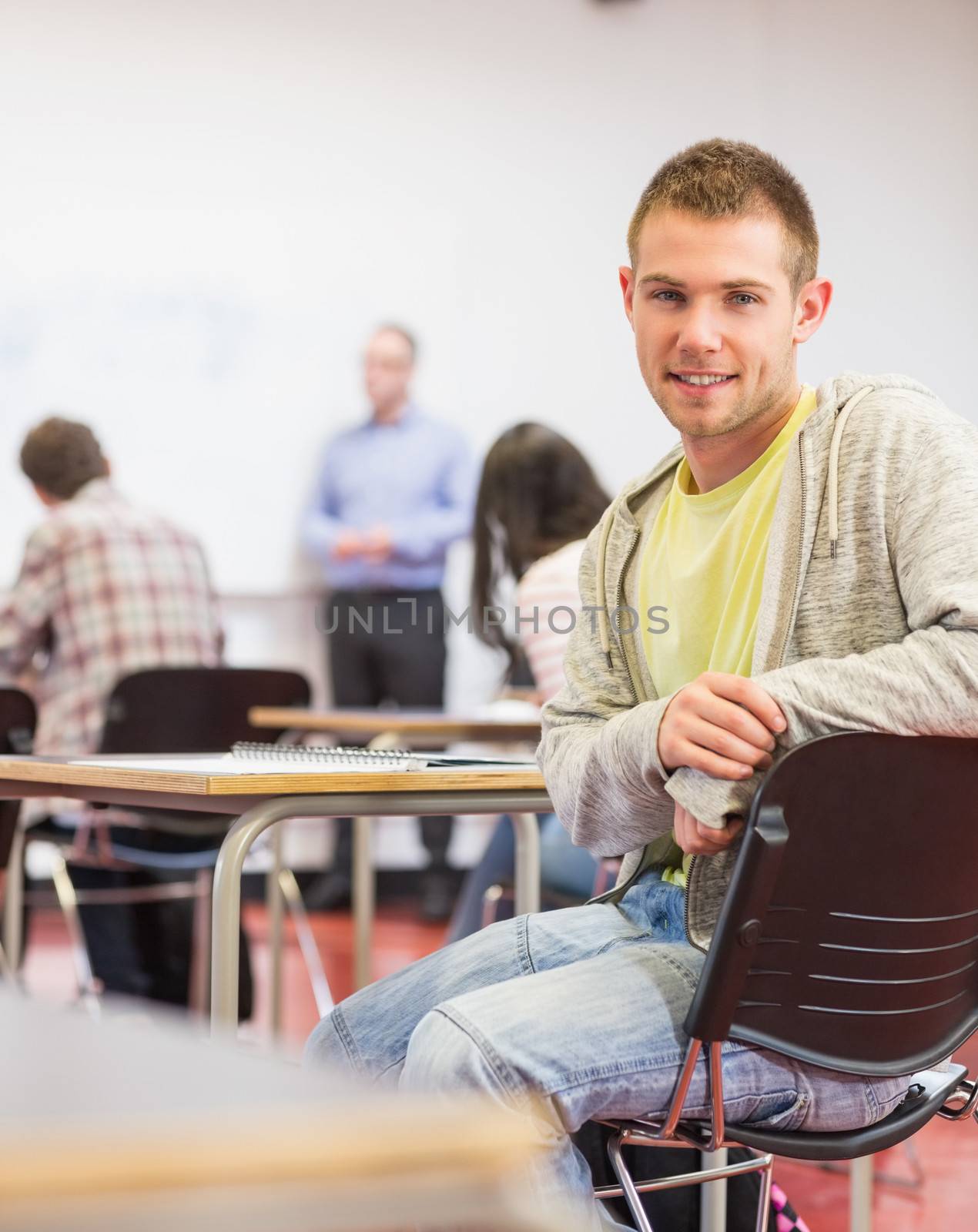 Male with blurred teachers students in classroom by Wavebreakmedia